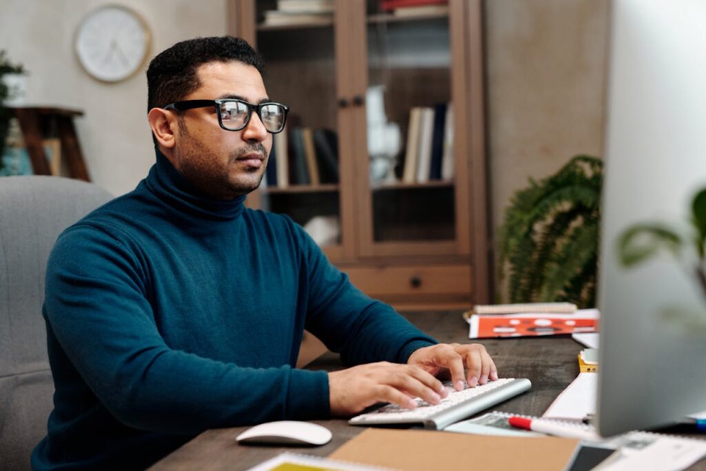 Professional working with multiple tools and tasks on desk in office