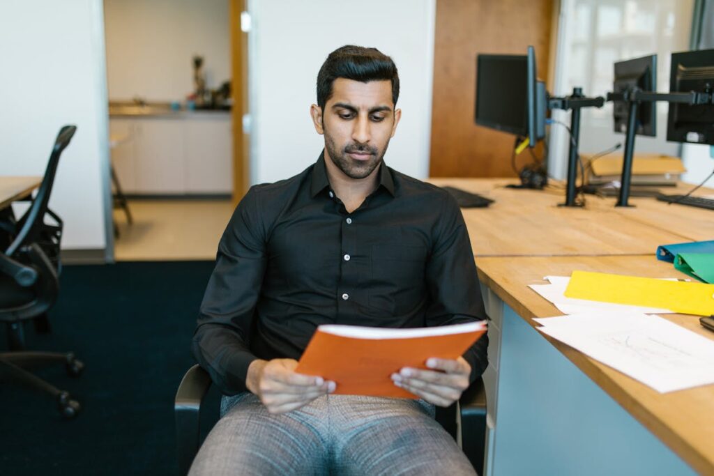 Professional reviewing a document with focused attention in an office setting