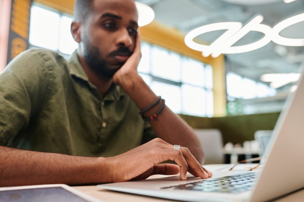 Professional reviewing his LinkedIn profile with a concerned expression