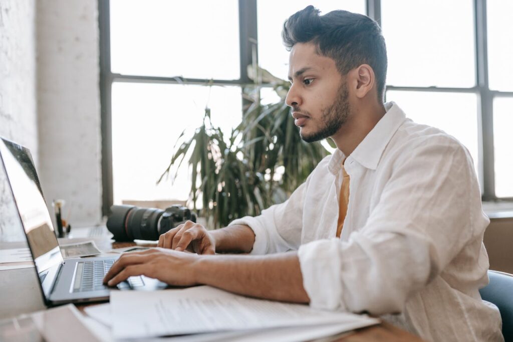 Professional working on laptop unaware of being evaluated online