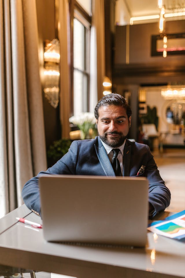 Senior professional working on a laptop in a premium setting, reflecting strong LinkedIn authority signals and credibility