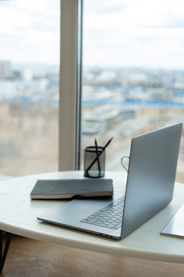 Minimal workspace with laptop representing LinkedIn profile as a digital first impression for professionals