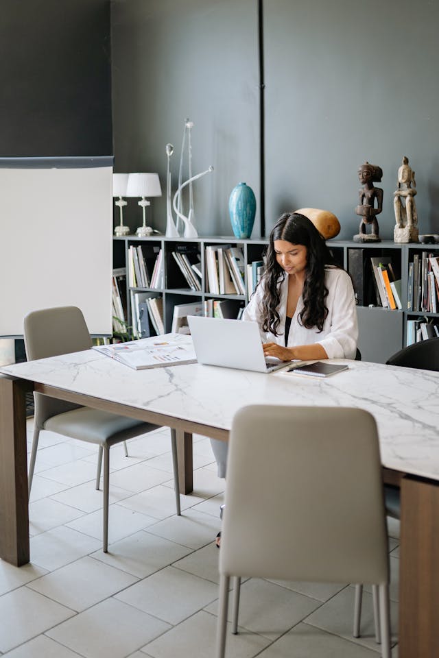 Professional working at a desk in a minimal setting, illustrating how vague language can make experience appear less defined