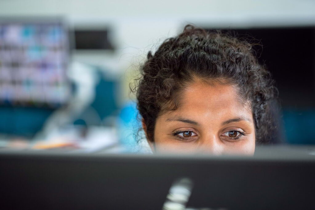 Close-up of a professional reading a screen, showing how vague LinkedIn summaries create weak or unclear impressions