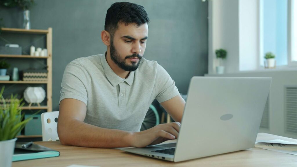 Professional working on a laptop, representing the challenge of expressing experience clearly in a LinkedIn summary