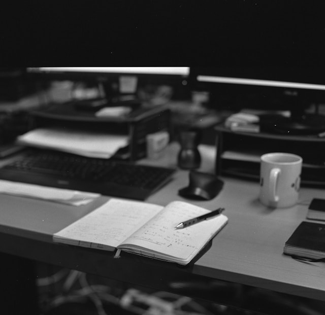 Notebook with written notes on a desk showing structured thinking and deliberate work process