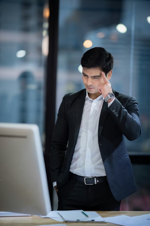 Senior corporate professional thoughtfully reviewing information in an office environment