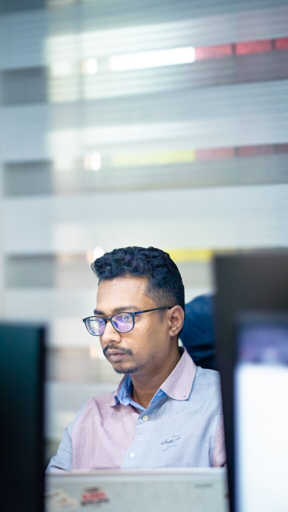 Professional corporate employee working quietly at a computer in an office environment