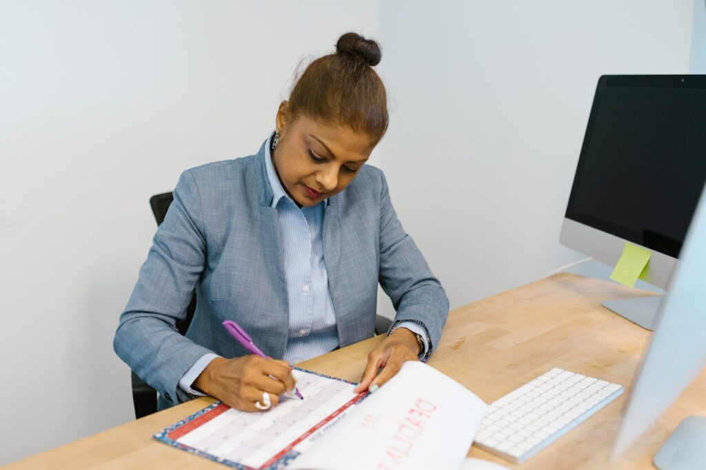 Professional reviewing and planning work tasks at an office desk