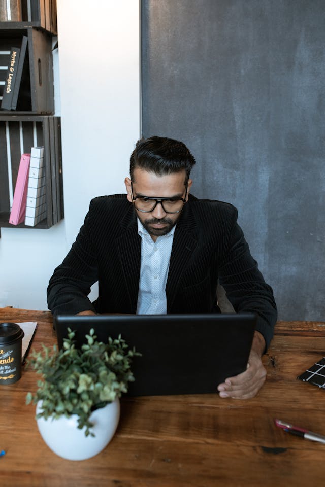 Professional reviewing documents and information at an office workstation