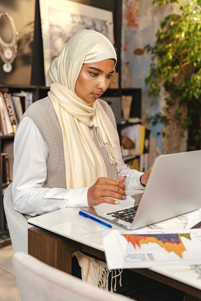 Professional reviewing information on a laptop in a modern workspace