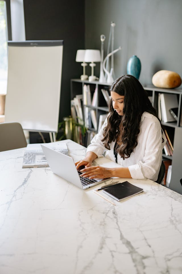 Professional working on a laptop in a calm modern office environment